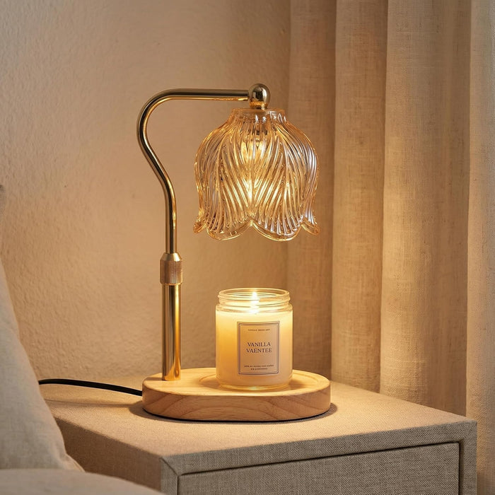 JONJOLI Classic Candle Warmer in gold beside a jar candle